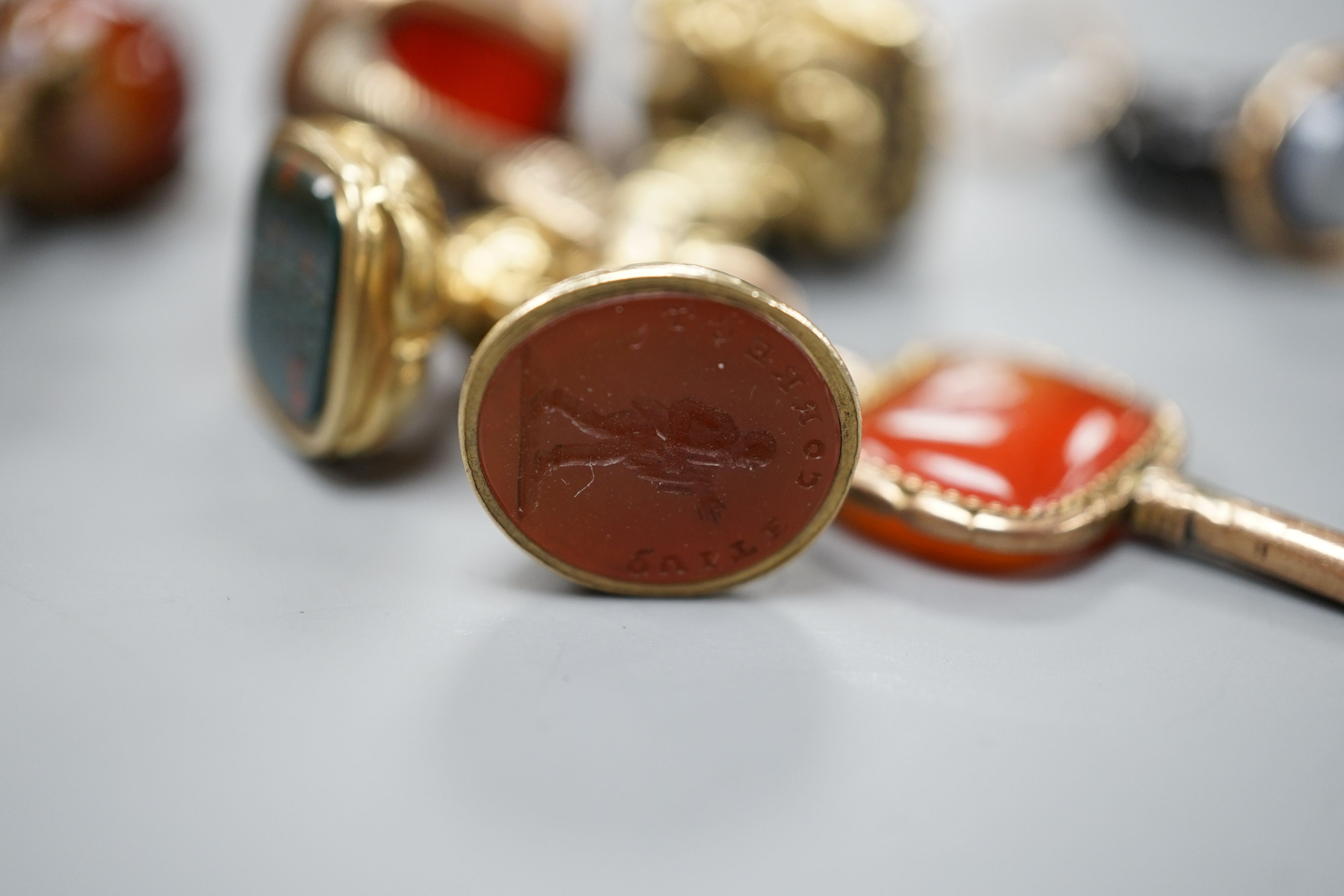 Eight assorted 19th century and later fob seals including a rose diamond set black glass dog with Roman head intaglio, 3cm, a gold overlaid and watch key